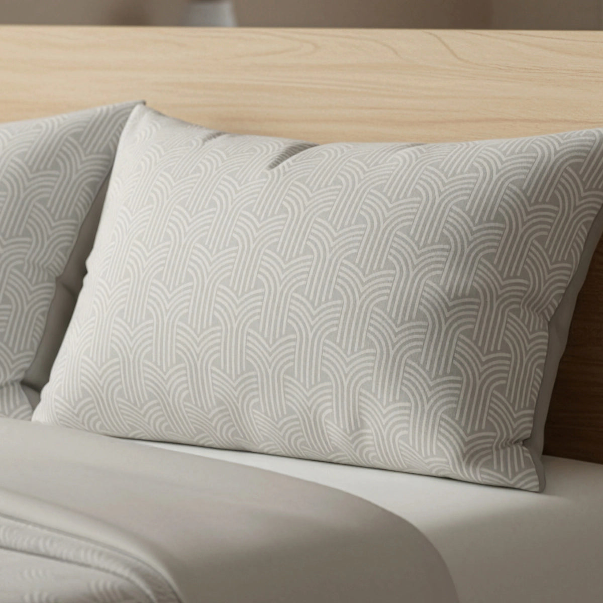 De Zelesta Flanel Art Kussenslopen set van 2 in taupe & grijs, met een subtiel geometrisch patroon en luxe rits om gemakkelijk te verwijderen en schoon te maken in de wasmachine, rust tegen een licht houten hoofdeinde op een netjes opgemaakt bed.