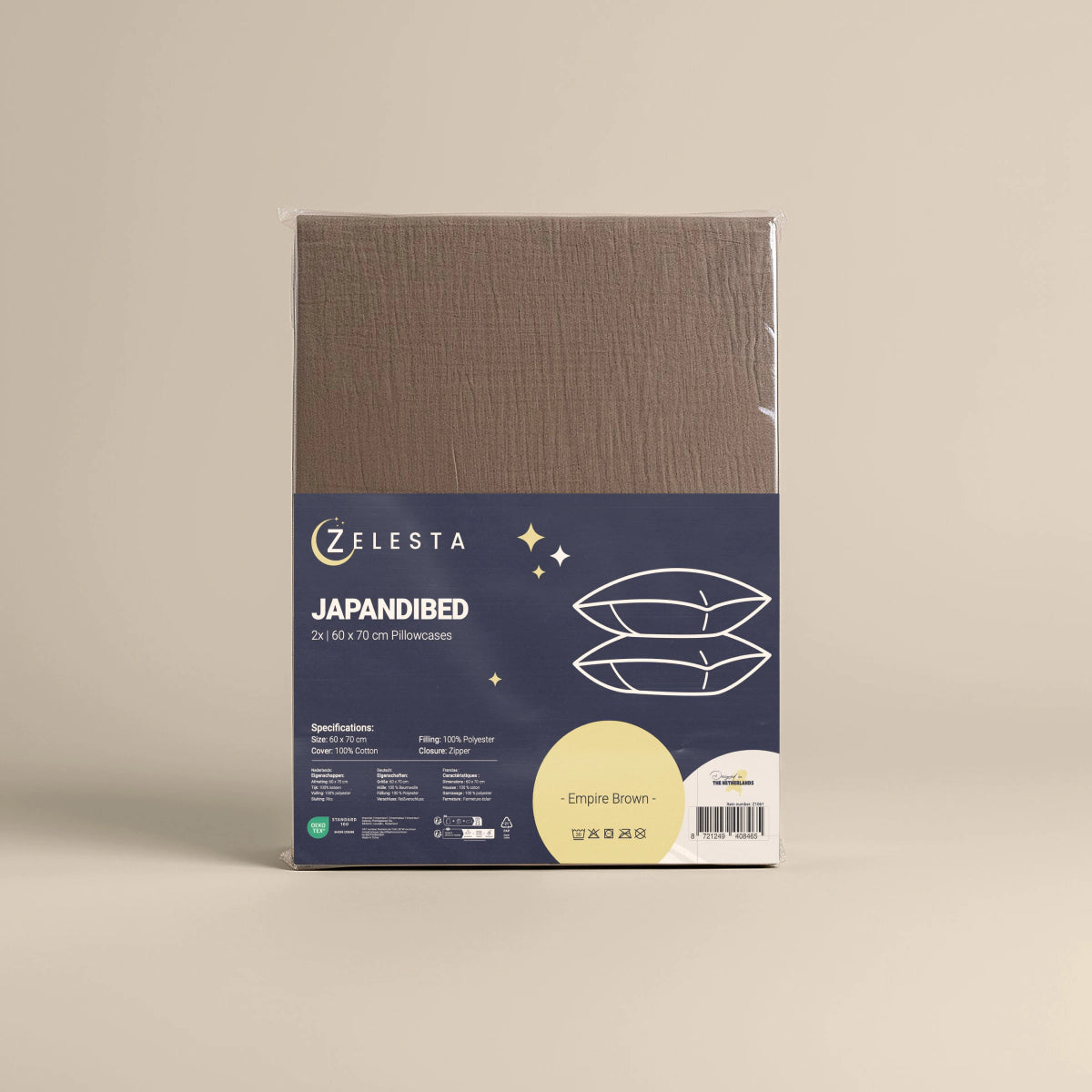 Een set van 2 Japandibed Katoen Mousseline kussenslopen in bruin (60x70 cm) wordt getoond tegen een beige achtergrond.