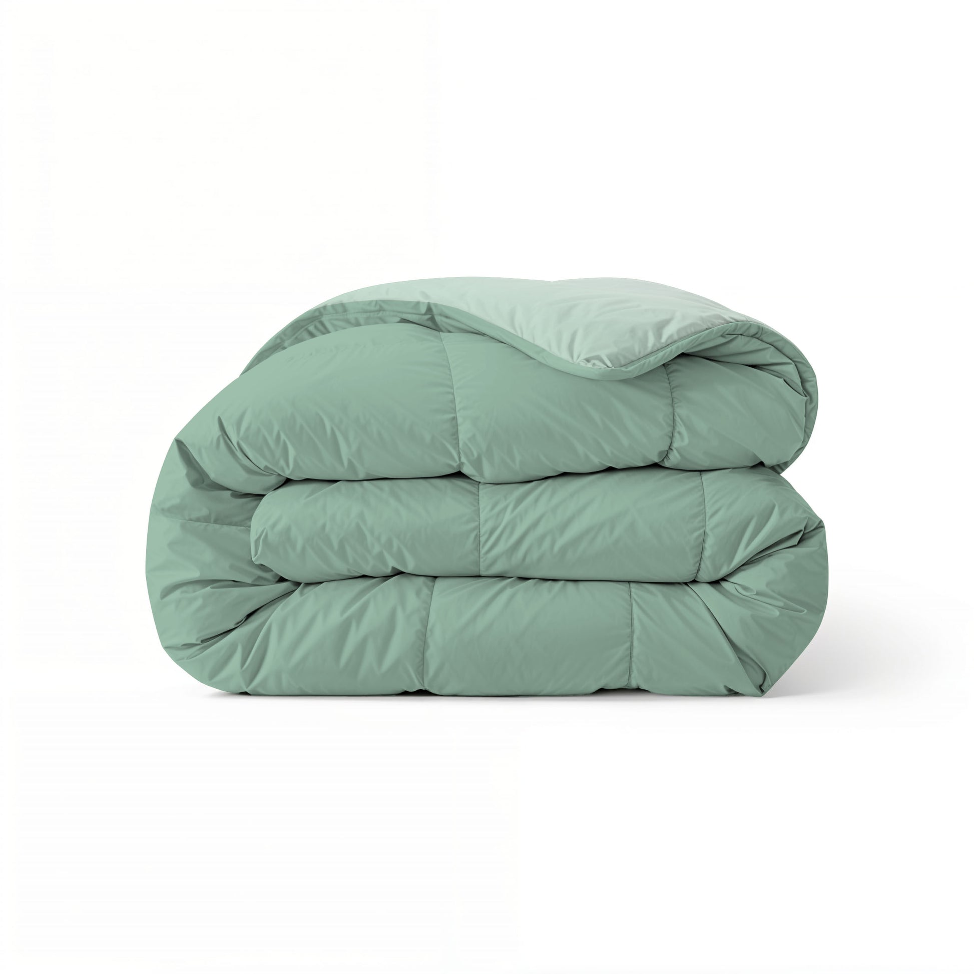 Het Zelesta Comfort Duo Dekbed in mintgroen en lichtgroen is netjes gevouwen op een witte achtergrond.