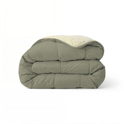 Het Zelesta Comfort Duo Dekbed, met een olijfgroene buitenkant en crèmekleurige binnenkant in een klassiek all-season design, is netjes opgevouwen en staat tegen een effen witte achtergrond.