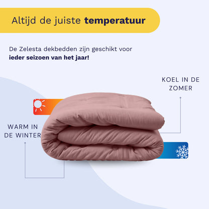 De Zelesta Japandibed Katoen Mousseline - Oud Roze is opgevouwen afgebeeld, met icoontjes die warmte in de winter en koelte in de zomer aangeven. In de Nederlandse tekst staat dat het perfect is voor alle seizoenen en is gemaakt van zacht mousseline katoen.