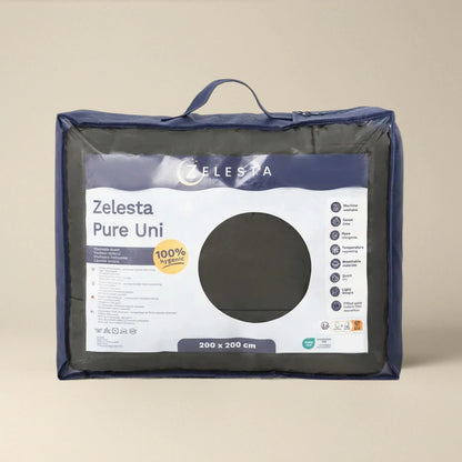 Het Zelesta Pure Uni Dekbed - Olijfzwart is verpakt met een duidelijk venster met de stof- en productgegevens. Het is 100% hygiënisch, biedt een ademend slaapcomfort en is verkrijgbaar in de maat 200 x 200 cm.